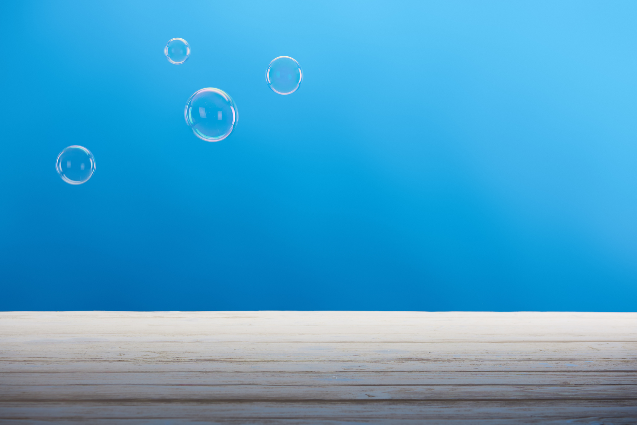clean soap bubbles and white surface on blue background